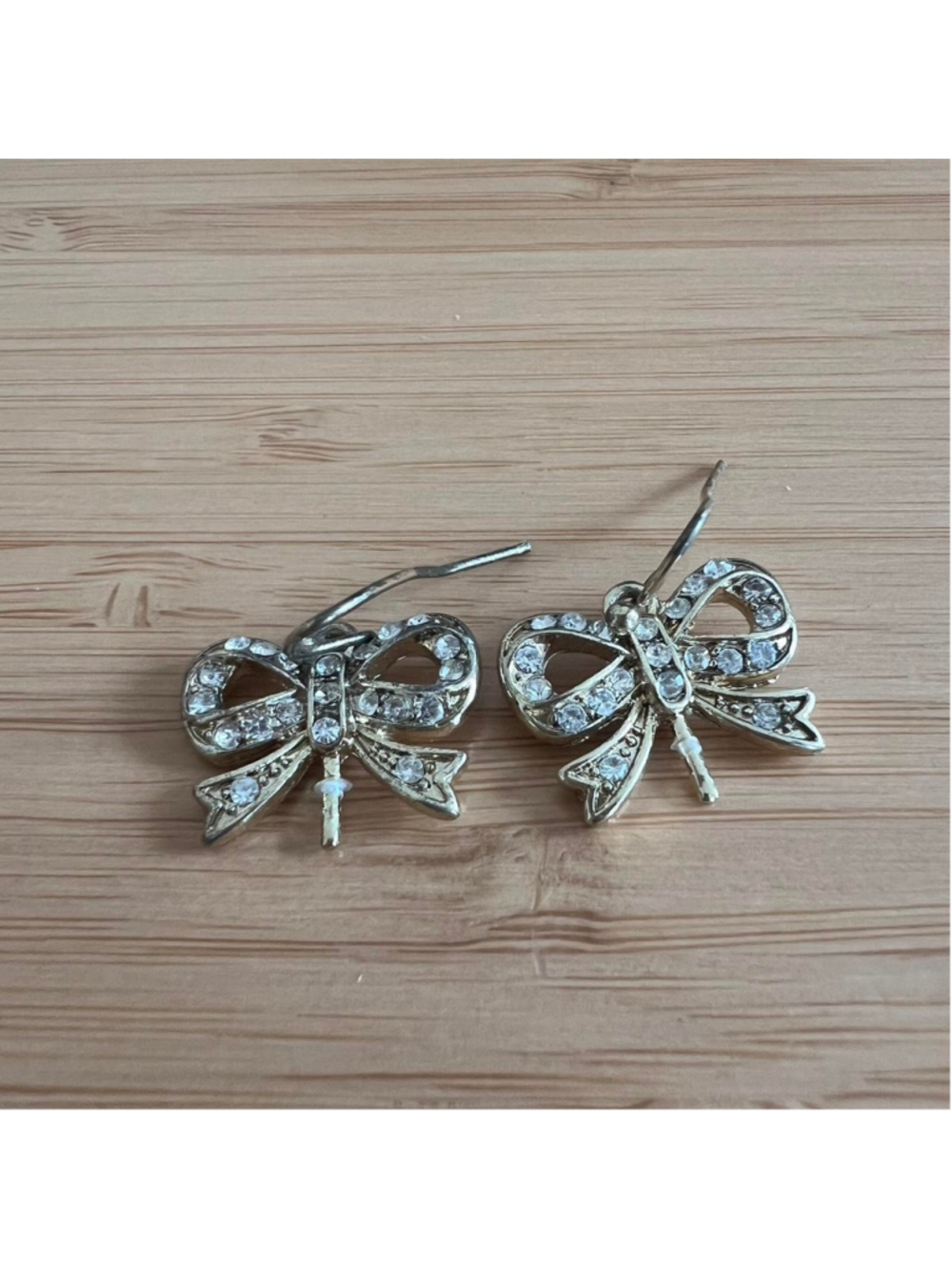 Gold tone rhinestone bow earrings